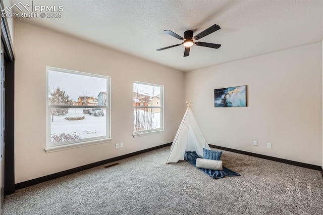 5687 Marshall Creek Dr, Colorado Springs, CO 80924 - playroom with carpet, a ceiling fan, baseboards, and a textured ceiling