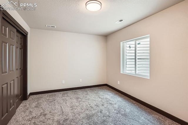 5687 Marshall Creek Dr, Colorado Springs, CO 80924 - unfurnished bedroom with carpet flooring, a textured ceiling, baseboards, and a closet