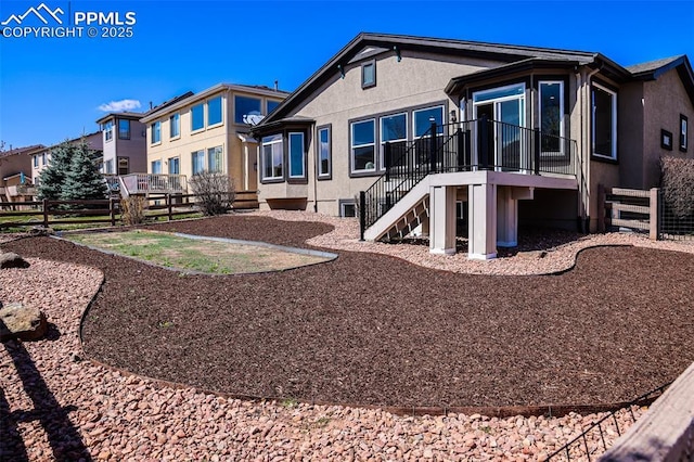 5687 Marshall Creek Dr, Colorado Springs, CO 80924 - back of property featuring a fenced backyard, stairs, stucco siding, and a deck