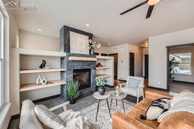 5687 Marshall Creek Dr, Colorado Springs, CO 80924 - living room with baseboards, ceiling fan, a stone fireplace, carpet floors, and recessed lighting