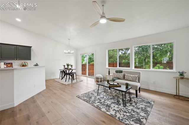 4530 Star Ridge Dr, Colorado Springs, CO 80916 - living area featuring lofted ceiling, a ceiling fan, a chandelier, light wood-style floors, and baseboards