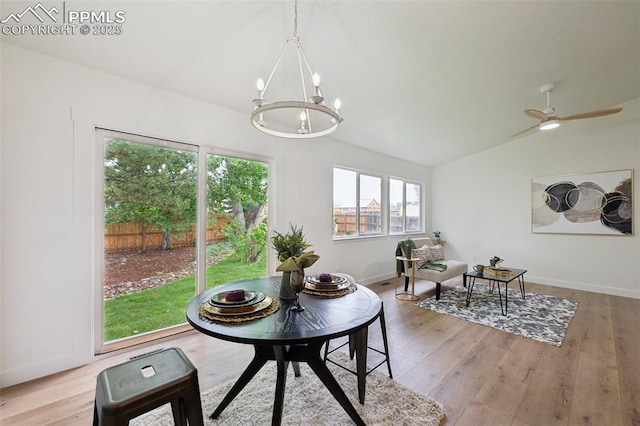 4530 Star Ridge Dr, Colorado Springs, CO 80916 - dining room featuring a chandelier, vaulted ceiling, light wood finished floors, and baseboards