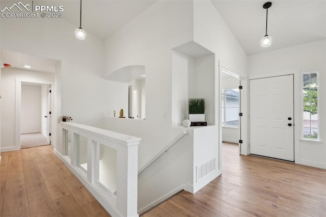 4530 Star Ridge Dr, Colorado Springs, CO 80916 - entryway featuring light wood-style flooring, arched walkways, baseboards, and lofted ceiling