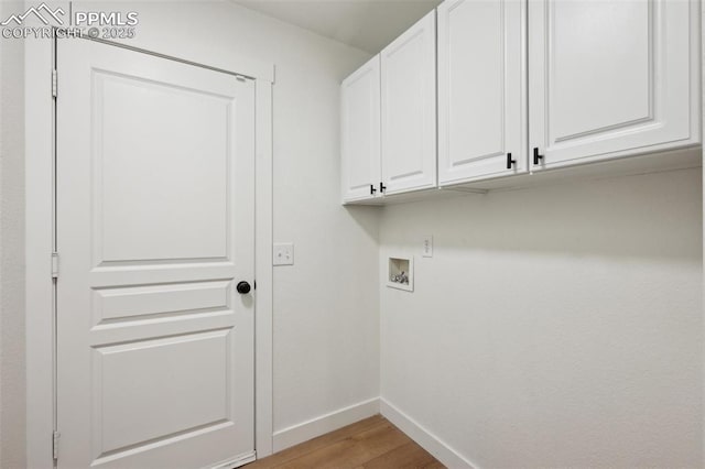 4530 Star Ridge Dr, Colorado Springs, CO 80916 - washroom with cabinet space, baseboards, hookup for a washing machine, and light wood-type flooring