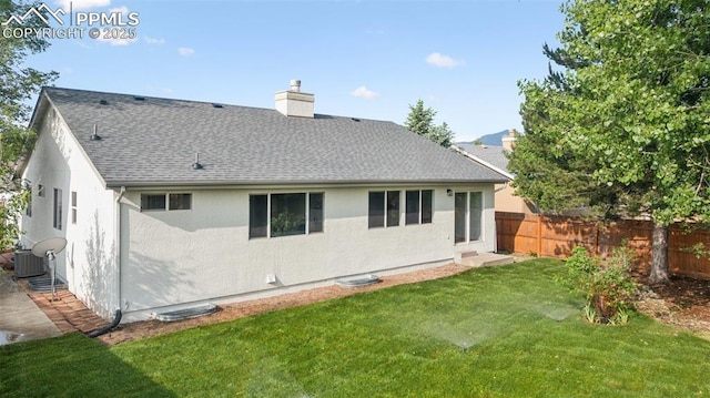 4530 Star Ridge Dr, Colorado Springs, CO 80916 - rear view of house with a shingled roof, a chimney, and central AC unit
