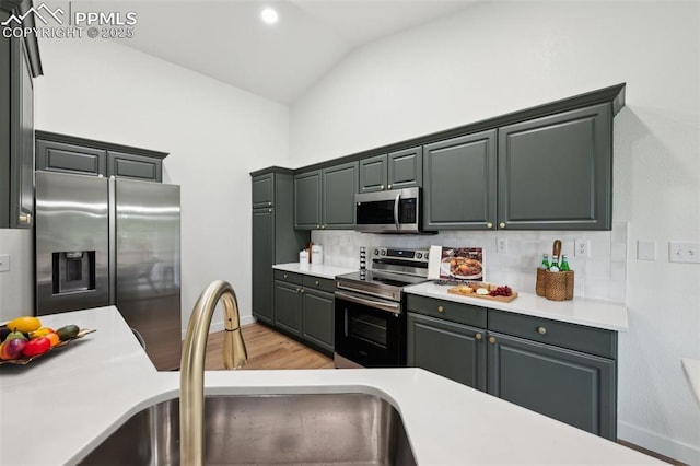 4530 Star Ridge Dr, Colorado Springs, CO 80916 - kitchen with stainless steel appliances, a sink, backsplash, light countertops, and light wood-type flooring