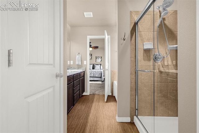 10881 Traders Pkwy, Fountain, CO 80817 - ensuite bathroom with wood finished floors, a stall shower, vanity, and ceiling fan