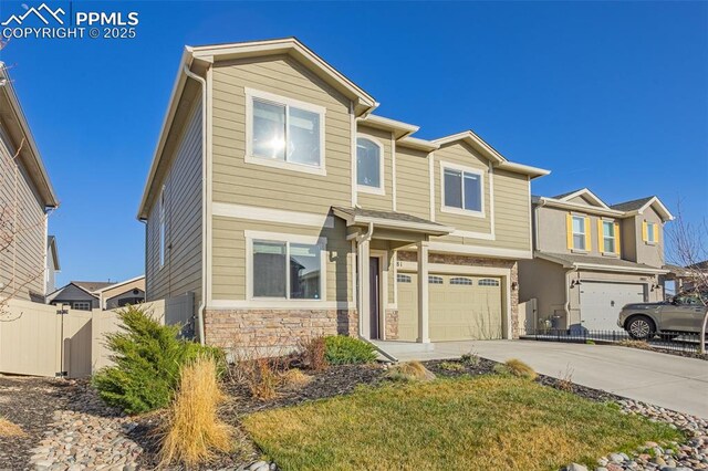 10881 Traders Pkwy, Fountain, CO 80817 - view of front of home featuring stone siding, a garage, and concrete driveway