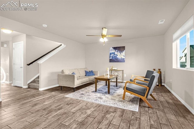 10881 Traders Pkwy, Fountain, CO 80817 - sitting room with wood finished floors, ceiling fan, baseboards, and stairs