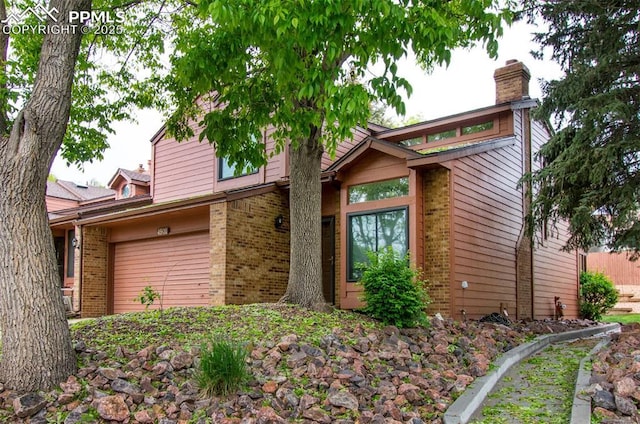 4901 Daybreak Cir, Colorado Springs, CO 80917 - mid-century inspired home with brick siding, a chimney, and a garage