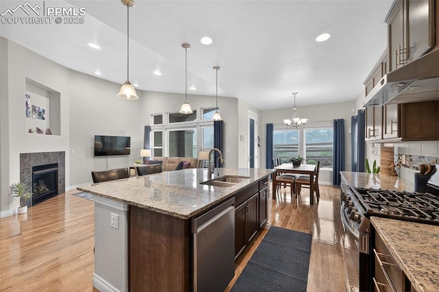 9661 Fresh Air Dr, Colorado Springs, CO 80924 - kitchen featuring stainless steel appliances, a sink, dark brown cabinets, a chandelier, and recessed lighting