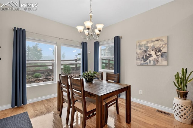9661 Fresh Air Dr, Colorado Springs, CO 80924 - dining space with a chandelier, baseboards, and light wood-style floors