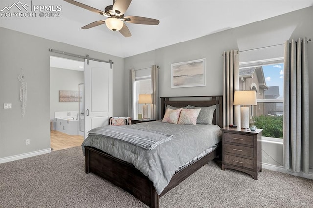 9661 Fresh Air Dr, Colorado Springs, CO 80924 - bedroom featuring light carpet, multiple windows, baseboards, and a barn door