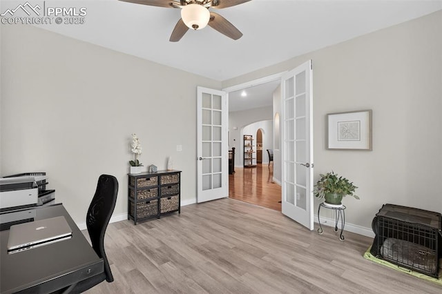 9661 Fresh Air Dr, Colorado Springs, CO 80924 - home office featuring french doors, arched walkways, a ceiling fan, light wood-style floors, and recessed lighting