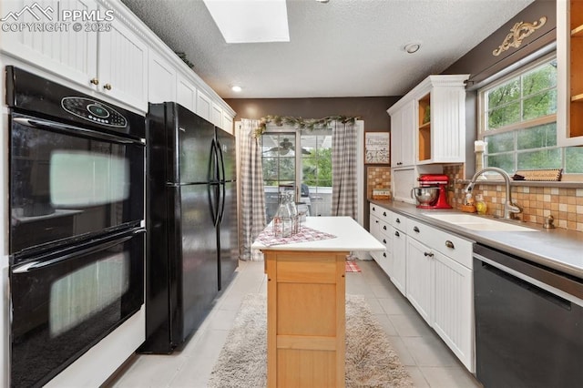 7475 Chirgiton Rd, Colorado Springs, CO 80908 - kitchen featuring black appliances, a sink, white cabinetry, decorative backsplash, and a textured ceiling