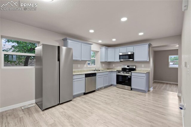 1205 Catalpa St, Pueblo, CO 81001 - kitchen featuring stainless steel appliances, a sink, light wood finished floors, baseboards, and recessed lighting