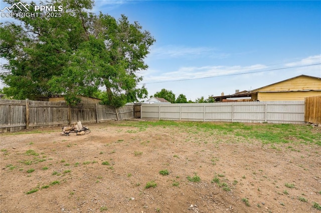 1205 Catalpa St, Pueblo, CO 81001 - fenced backyard featuring a fire pit