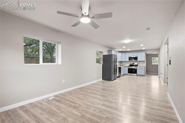 1205 Catalpa St, Pueblo, CO 81001 - unfurnished living room featuring light wood-style flooring, baseboards, a ceiling fan, and recessed lighting
