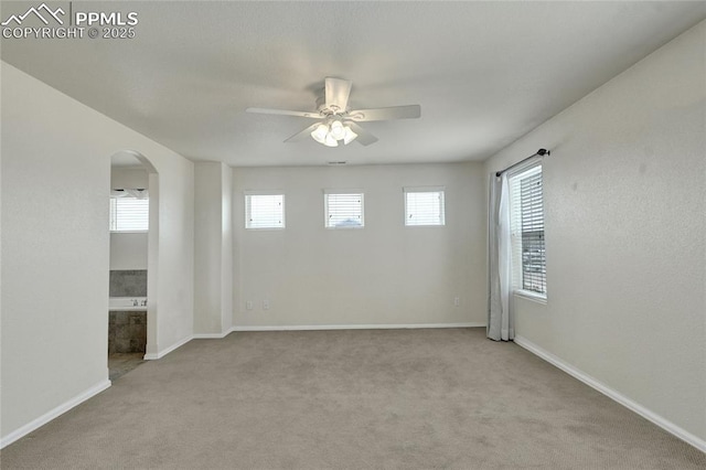 12213 Crystal Downs Rd, Peyton, CO 80831 - carpeted empty room featuring arched walkways, ceiling fan, and baseboards