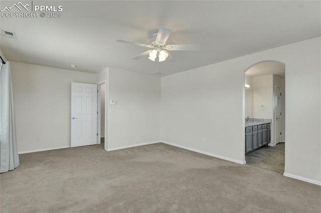 12213 Crystal Downs Rd, Peyton, CO 80831 - carpeted spare room with arched walkways, ceiling fan, and baseboards