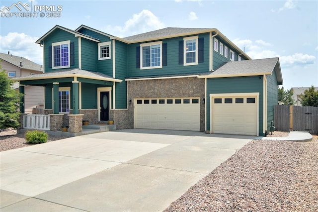 12213 Crystal Downs Rd, Peyton, CO 80831 - view of front of house featuring a porch, driveway, stone siding, a garage, and an attached garage