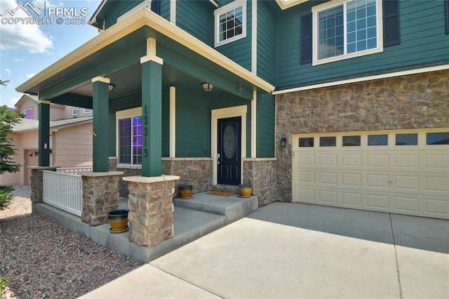 12213 Crystal Downs Rd, Peyton, CO 80831 - view of exterior entry with stone siding, a porch, an attached garage, and concrete driveway