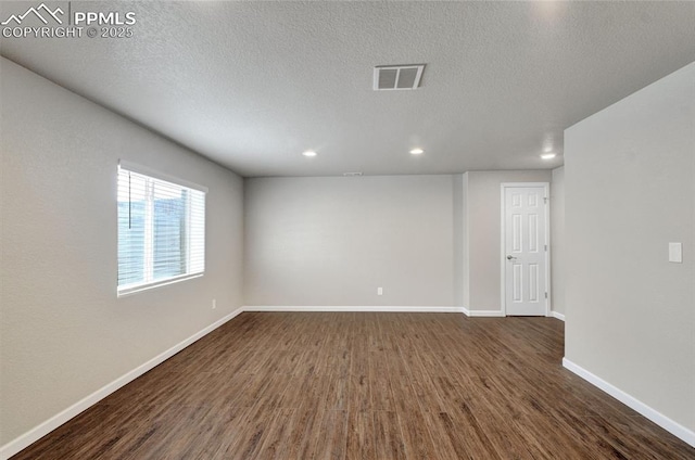 12213 Crystal Downs Rd, Peyton, CO 80831 - empty room with dark wood-type flooring, recessed lighting, baseboards, and a textured ceiling