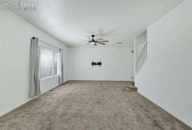12213 Crystal Downs Rd, Peyton, CO 80831 - carpeted empty room featuring a ceiling fan and stairway