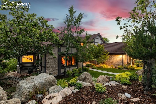 170 Salisbury Ct, Colorado Springs, CO 80906 - back of property at dusk with stone siding and a tiled roof