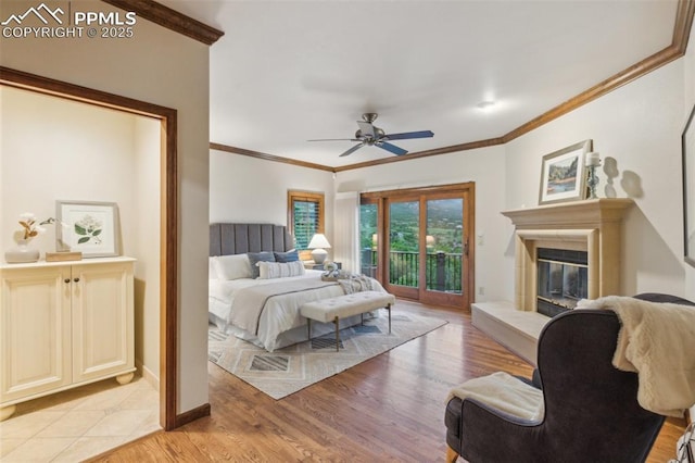 170 Salisbury Ct, Colorado Springs, CO 80906 - bedroom featuring access to exterior, ornamental molding, a glass covered fireplace, light wood-style floors, and a ceiling fan