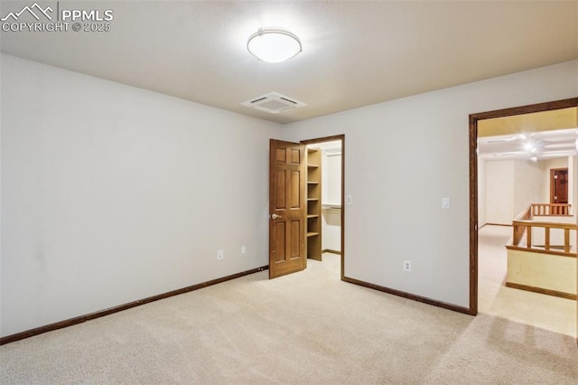 170 Salisbury Ct, Colorado Springs, CO 80906 - unfurnished bedroom with light colored carpet, baseboards, and a walk in closet