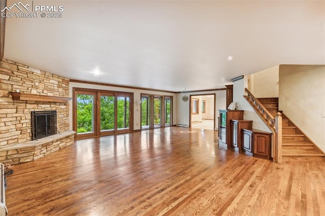 170 Salisbury Ct, Colorado Springs, CO 80906 - unfurnished living room with wood finished floors, crown molding, a fireplace, and stairway