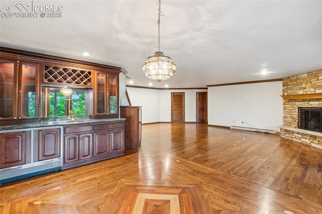 170 Salisbury Ct, Colorado Springs, CO 80906 - indoor bar featuring a chandelier, pendant lighting, a stone fireplace, crown molding, and recessed lighting