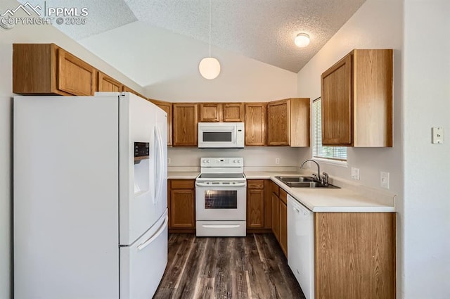 869 Marshall Dr, Fountain, CO 80817 - kitchen with white appliances, brown cabinets, lofted ceiling, a sink, and a textured ceiling
