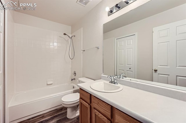 869 Marshall Dr, Fountain, CO 80817 - bathroom featuring toilet, wood finished floors, vanity, and shower / bath combination