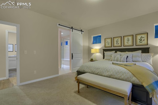 16277 Gammon Ct, Monument, CO 80132 - carpeted bedroom with a barn door, ensuite bathroom, and baseboards