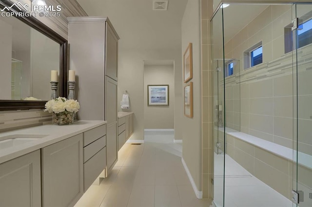 16277 Gammon Ct, Monument, CO 80132 - bathroom featuring vanity, a stall shower, tile patterned flooring, and baseboards