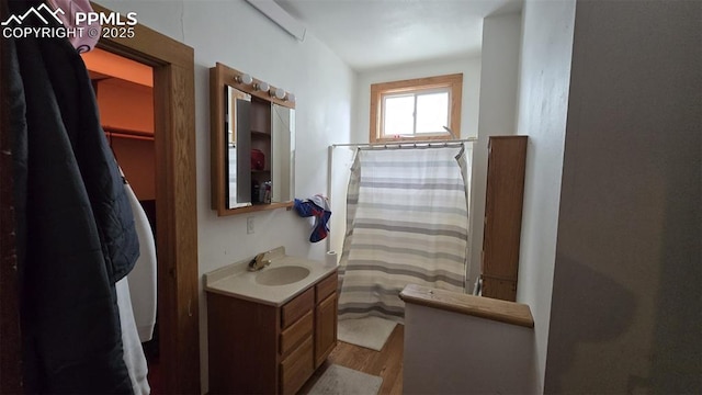 414 7th St, Hugo, CO 80821 - full bathroom with wood finished floors, vanity, and curtained shower