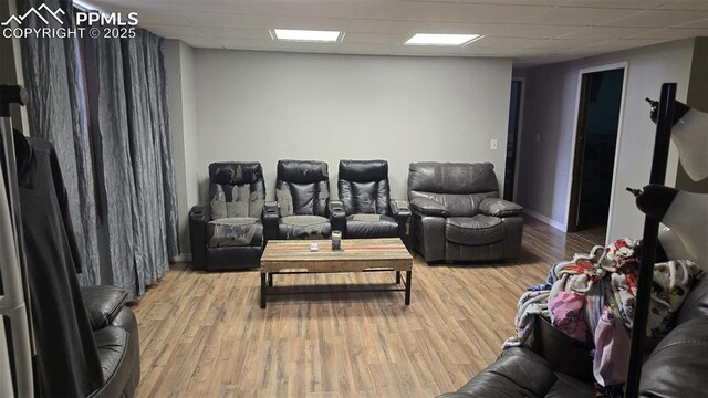 414 7th St, Hugo, CO 80821 - home theater room with a drop ceiling, wood finished floors, and baseboards