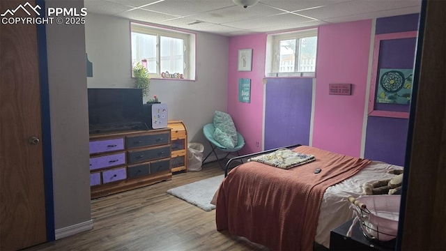 414 7th St, Hugo, CO 80821 - bedroom with wood finished floors, a paneled ceiling, and multiple windows