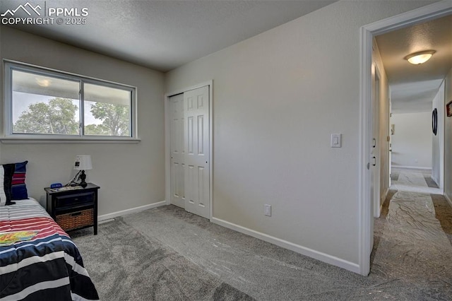 1135 Server Dr, Colorado Springs, CO 80910 - bedroom featuring carpet floors, baseboards, a closet, and a textured ceiling