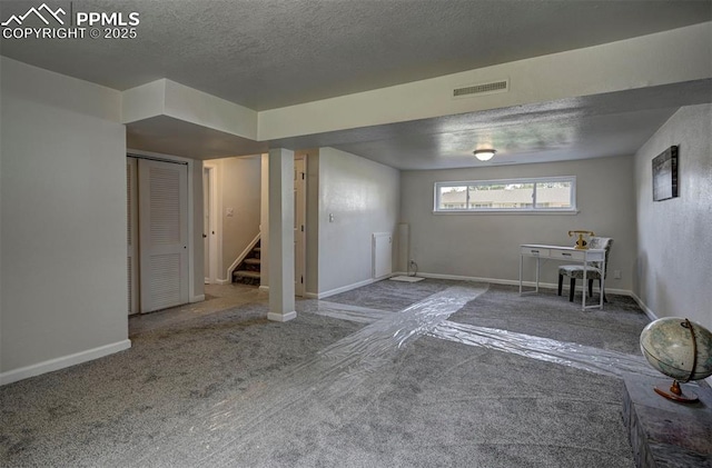 1135 Server Dr, Colorado Springs, CO 80910 - below grade area featuring stairway, baseboards, carpet flooring, and a textured ceiling