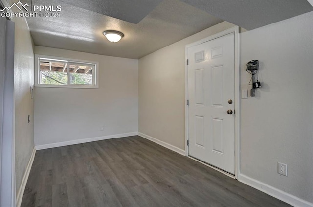 1135 Server Dr, Colorado Springs, CO 80910 - empty room featuring dark wood finished floors, baseboards, and a textured ceiling