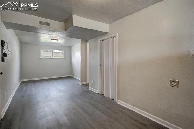 1135 Server Dr, Colorado Springs, CO 80910 - spare room with wood finished floors, baseboards, and a textured ceiling