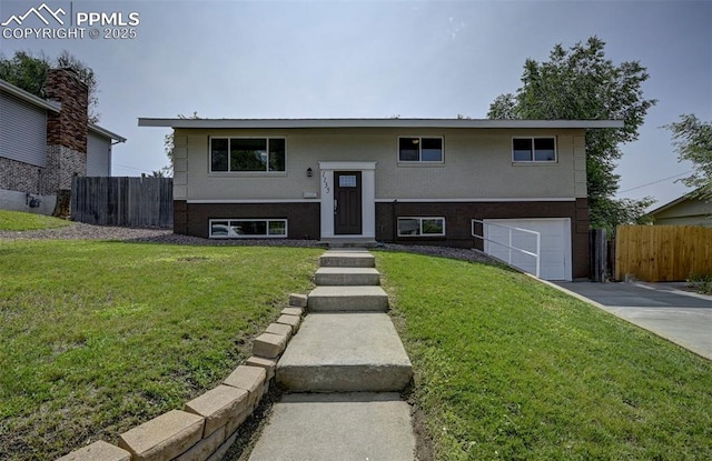1135 Server Dr, Colorado Springs, CO 80910 - bi-level home featuring a garage, driveway, and brick siding