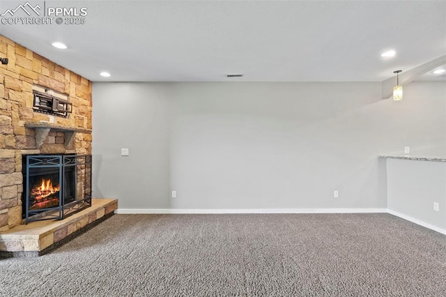 128 W Rockrimmon Blvd Unit 105, Colorado Springs, CO 80919 - unfurnished living room with recessed lighting, a stone fireplace, and carpet floors
