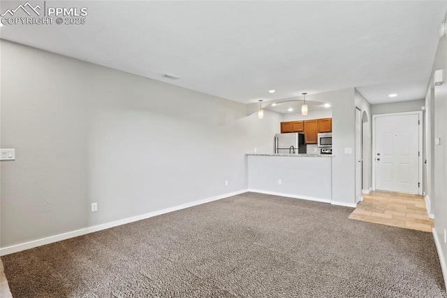 128 W Rockrimmon Blvd Unit 105, Colorado Springs, CO 80919 - unfurnished living room featuring carpet floors and recessed lighting