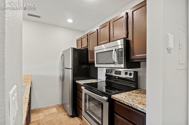 128 W Rockrimmon Blvd Unit 105, Colorado Springs, CO 80919 - kitchen with appliances with stainless steel finishes, light stone counters, light stone finish floors, and recessed lighting