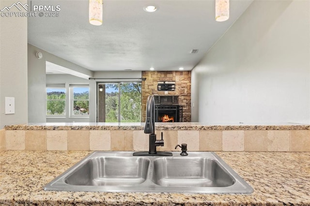128 W Rockrimmon Blvd Unit 105, Colorado Springs, CO 80919 - kitchen with a stone fireplace, recessed lighting, and open floor plan
