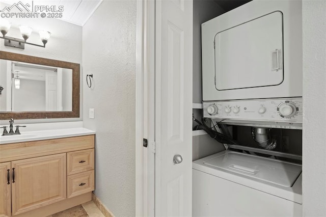 128 W Rockrimmon Blvd Unit 105, Colorado Springs, CO 80919 - laundry area featuring estacked washer and dryer and a textured wall
